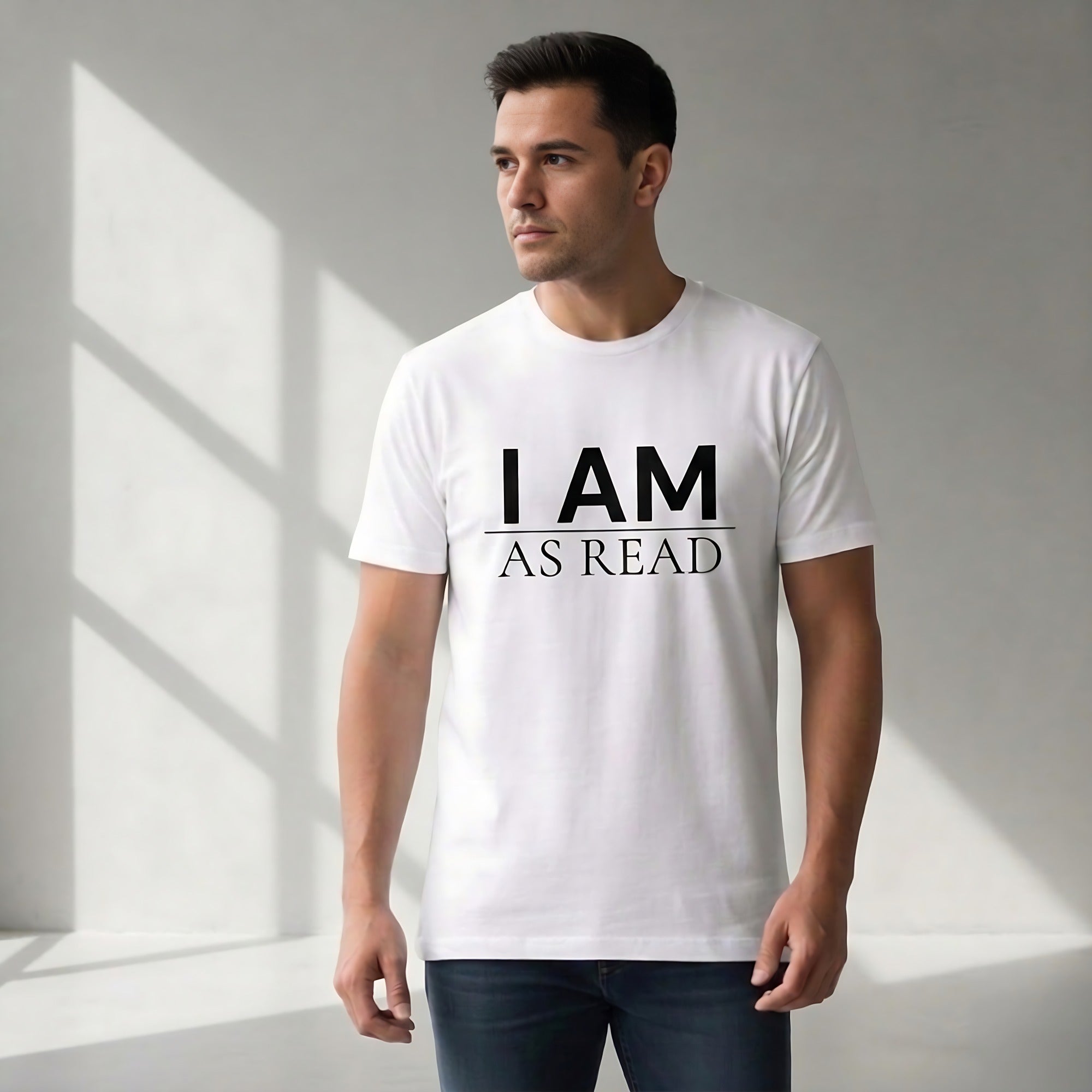 Man wearing a white t-shirt with 'I AM AS READ' text in a minimalistic setting.