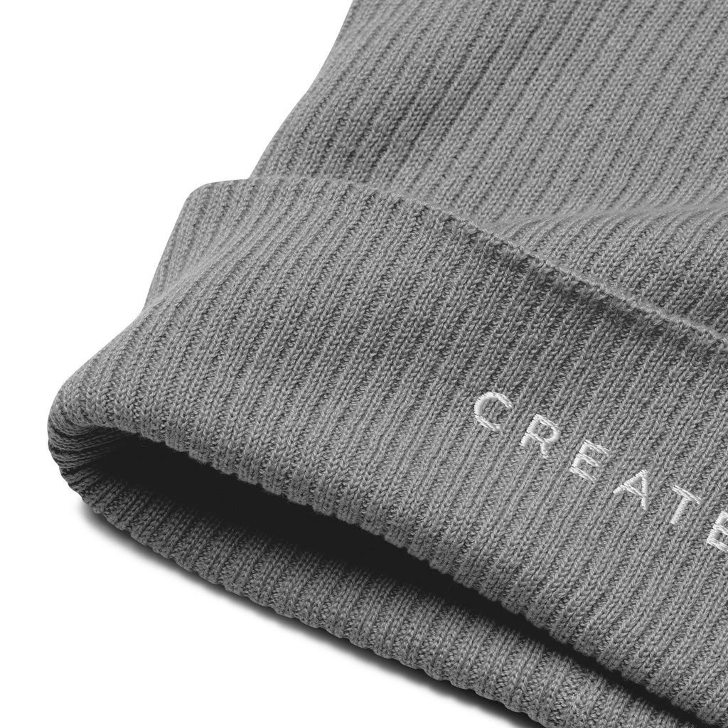 Grey knit beanie with 'CREATED' embroidery on a white background.