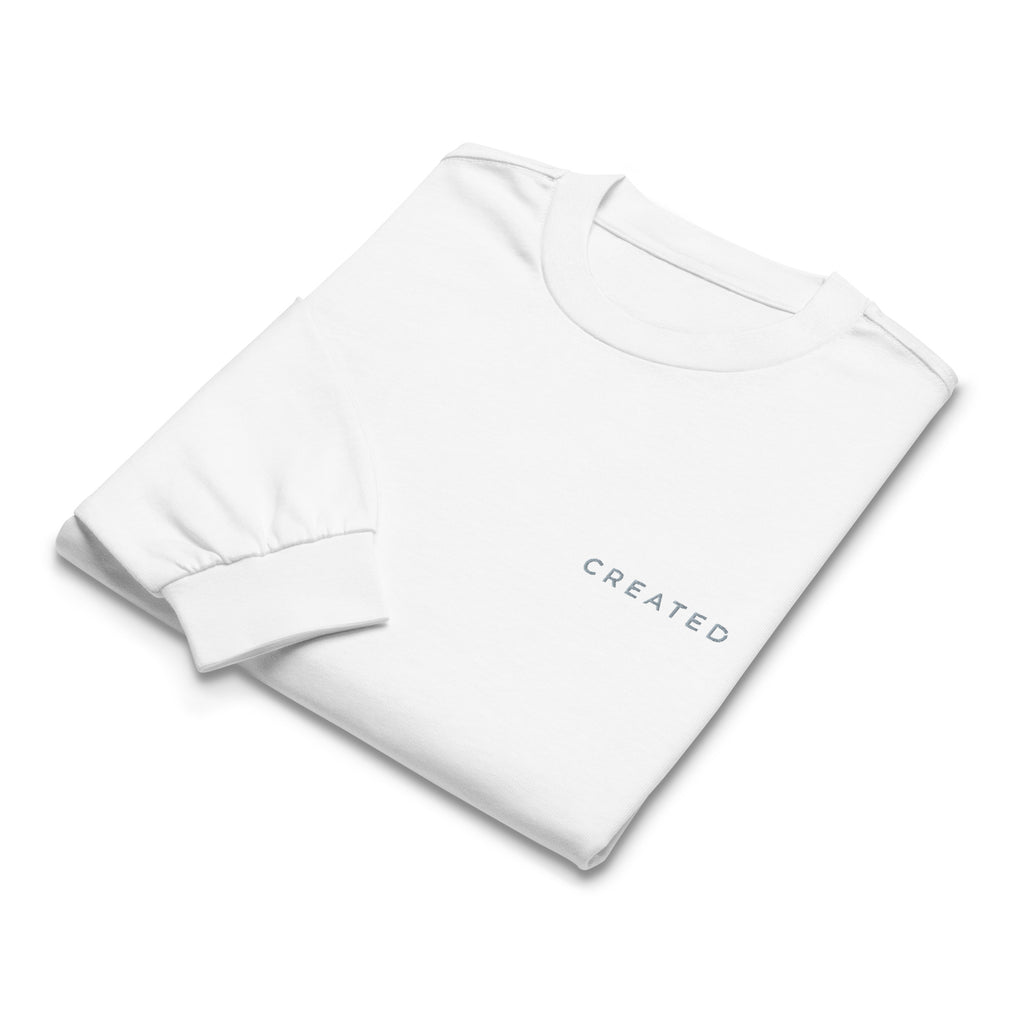 White long sleeve t-shirt with 'CREATED' text on a white background.