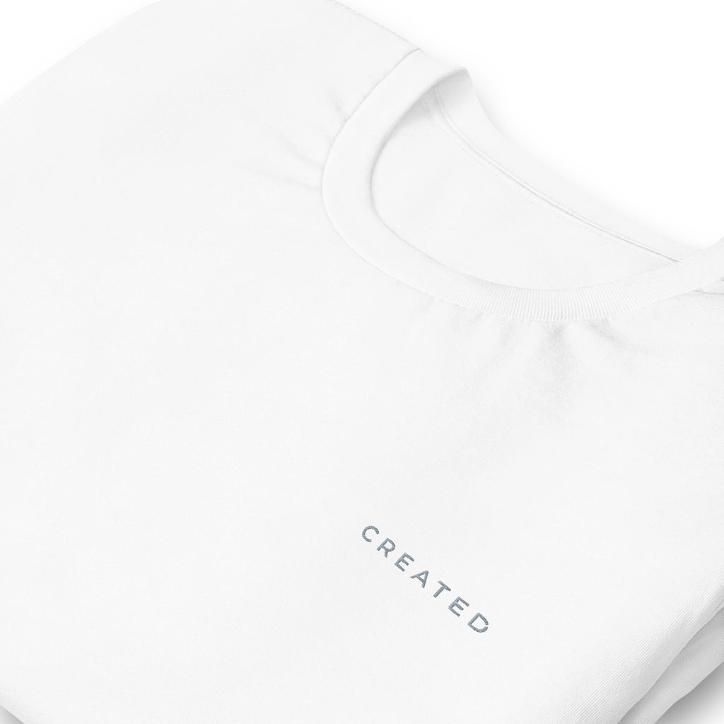 White t-shirt with 'CREATED' text on a white background.