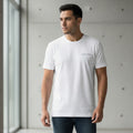 Man wearing a white t-shirt with a 'CREATED' logo in a minimalistic setting.